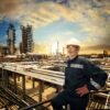A worker overlooks an oil refinery plant.