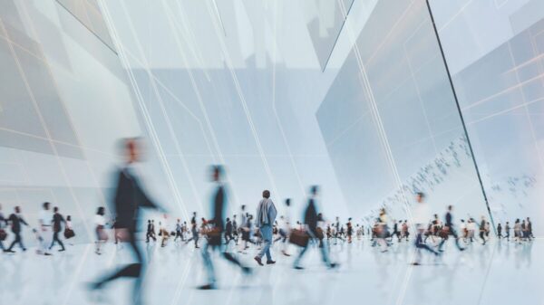 workers walk through an office building
