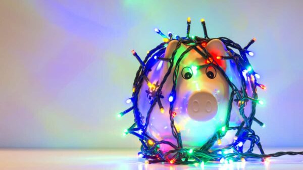 Piggy bank wrapped in Christmas string lights